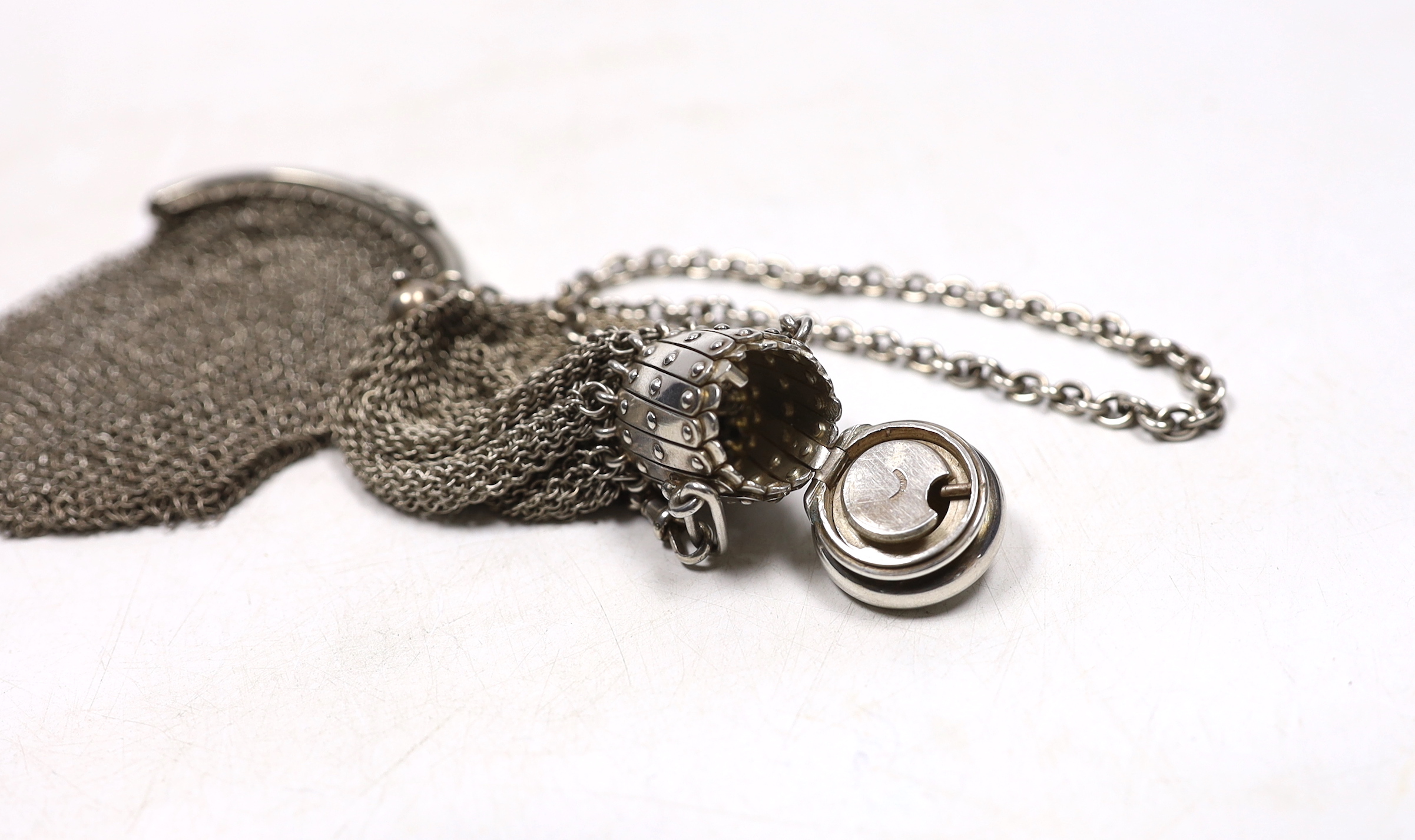 A miser's purse on suspension chain, together with a mesh evening purse.
